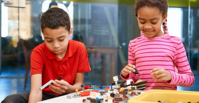 African girl and boy creating toys