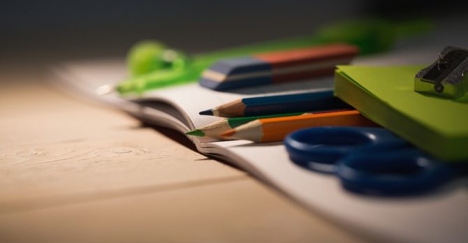 Students table with school supplies on it